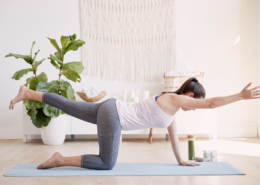 woman doing yoga in her home to relieve stress and relax, natural light and calming atmosphere